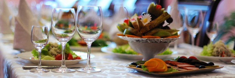 Wine glasses lined up on dinner table