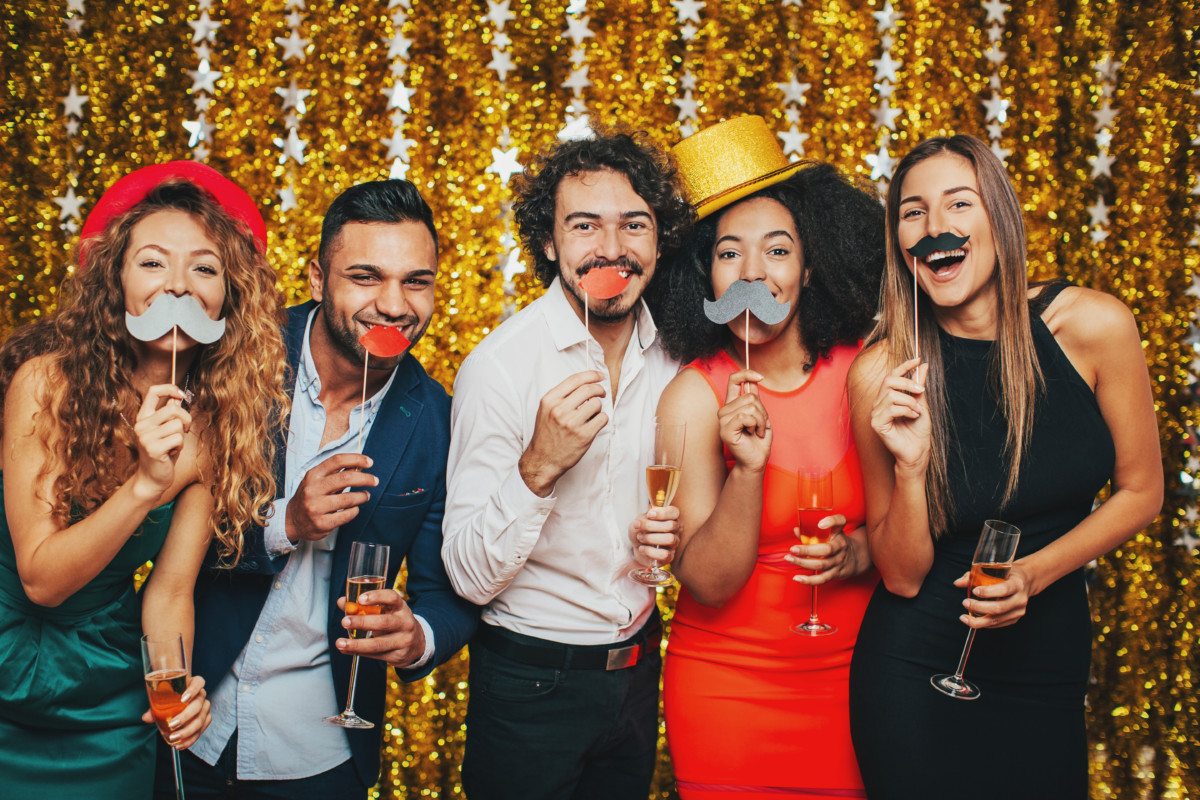 Multi-ethnic group of people having fun and drinking champagne on a formal party.